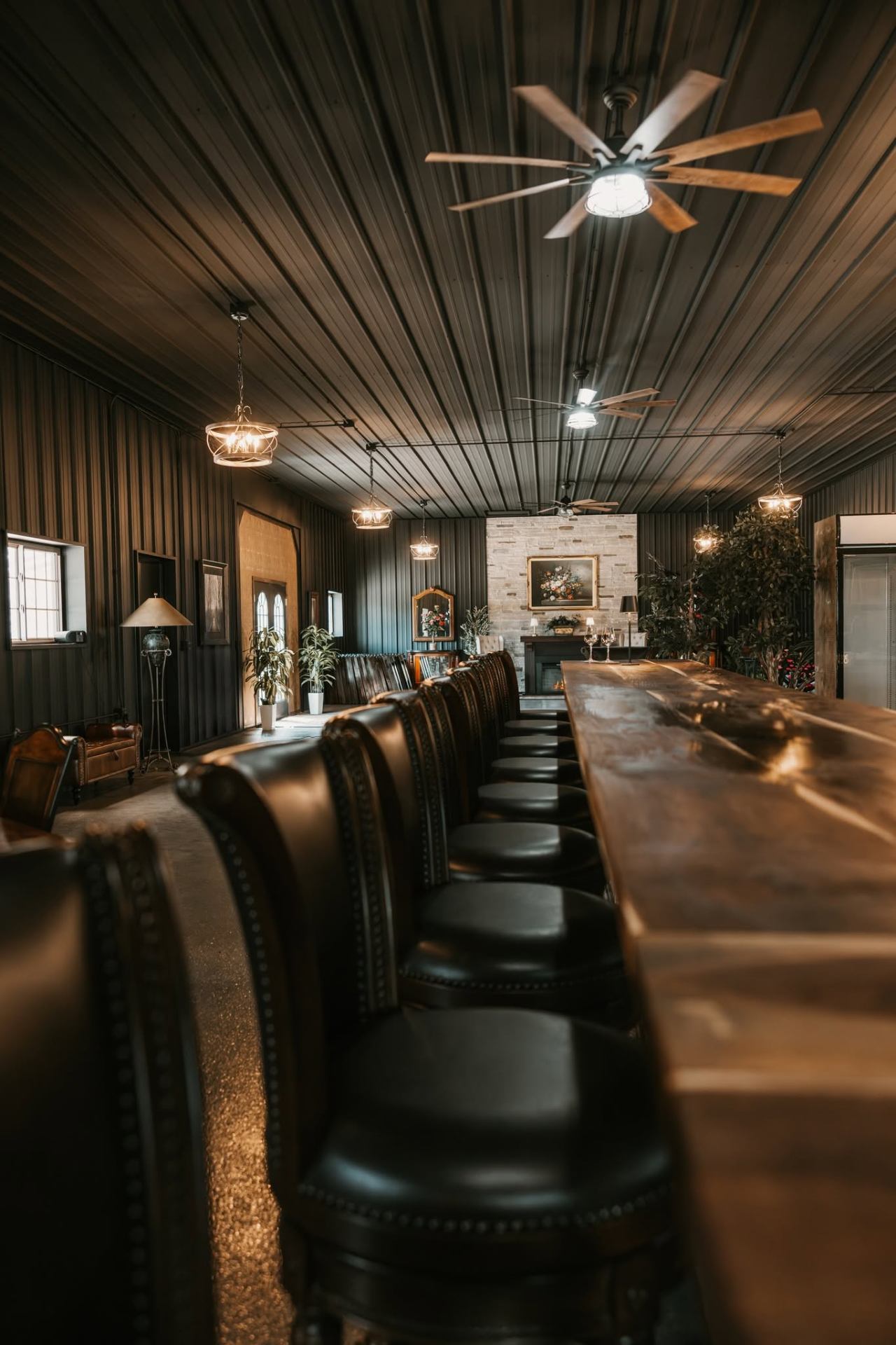 Long wooden bar with leather stools